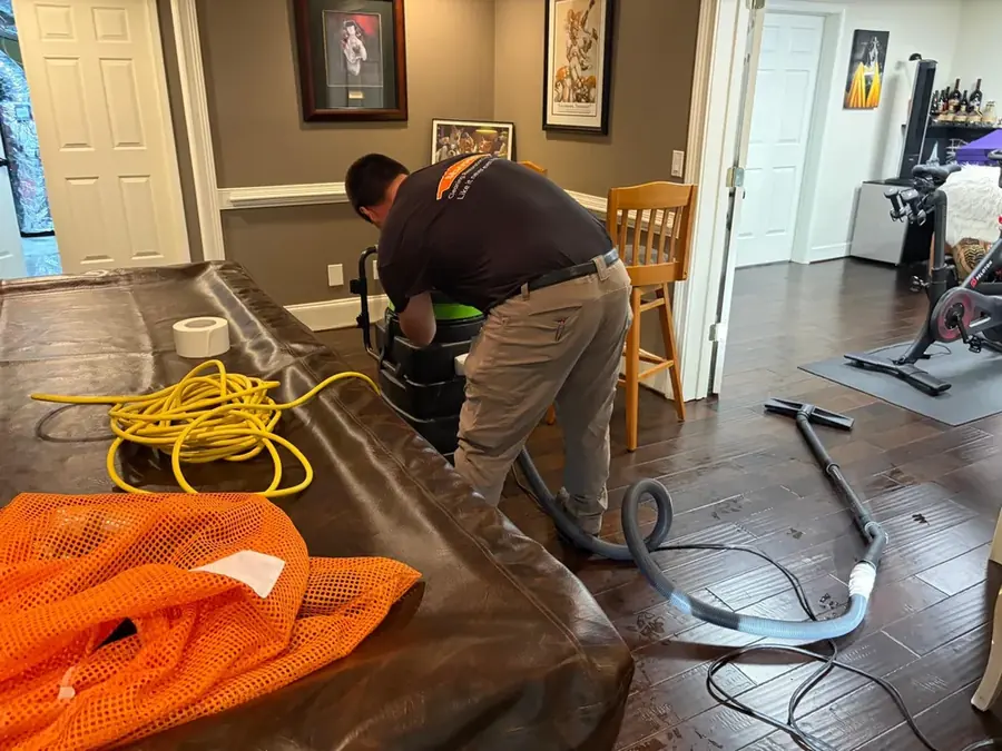 Water pumped from a basement after a sump pump failed in Cary
