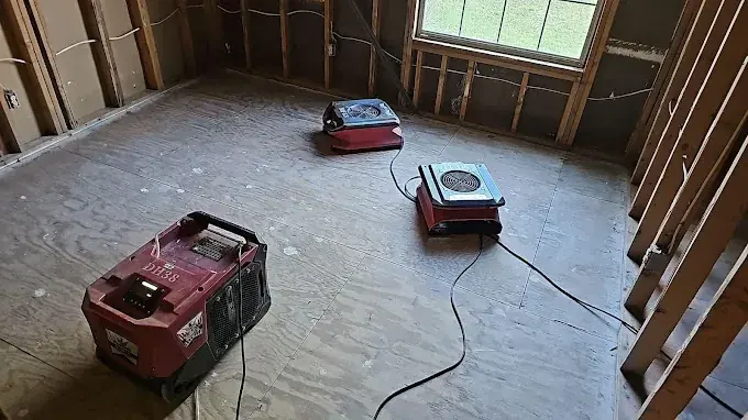 Restoration technician checking a moisture reading in a Cary home