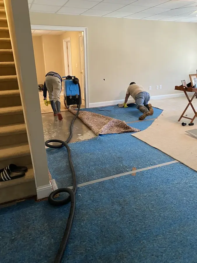 Flooded finished basement being pumped out in Cary