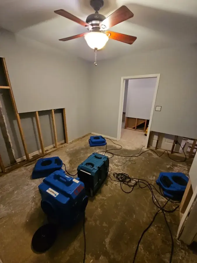 Air movers and dehumidifiers drying a Cary room